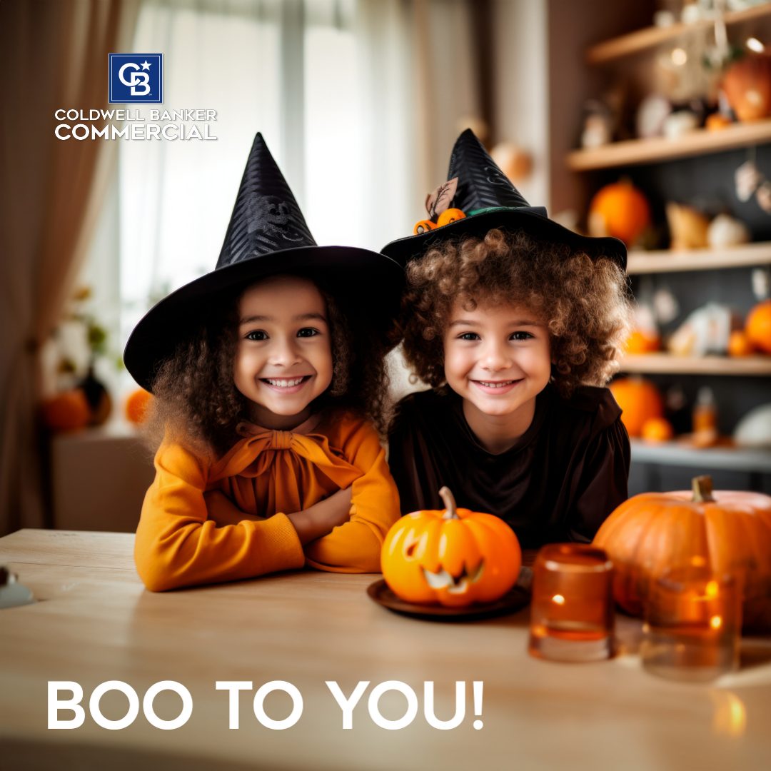 2 children with pumpkins and witches hats